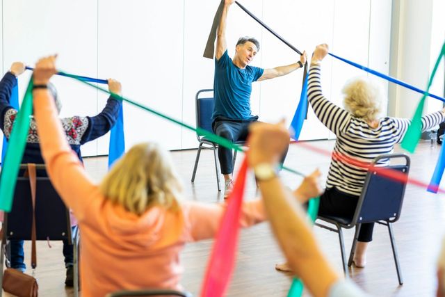 A group exercising with resistance bands in a community class