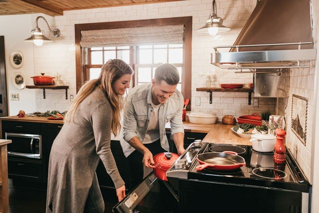 Two people cooking together in a home kitchen